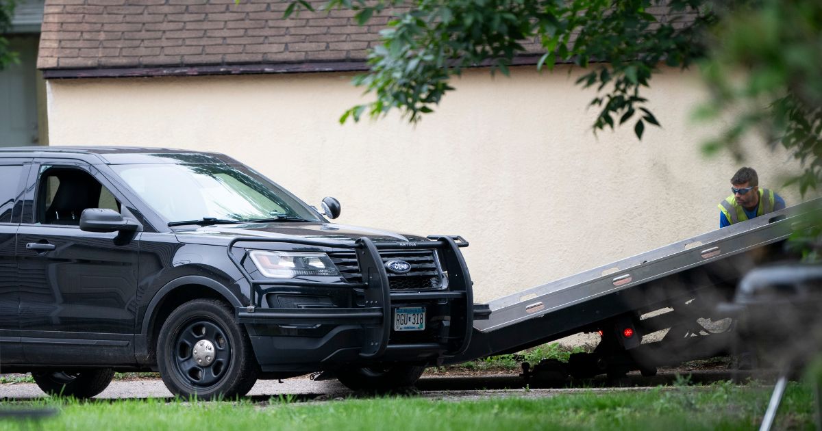 A vehicle belonging to Vance Boelter, allegedly made to look like a police car, is towed from the alley behind his home on June 14, 2025, in Minneapolis, Minnesota.