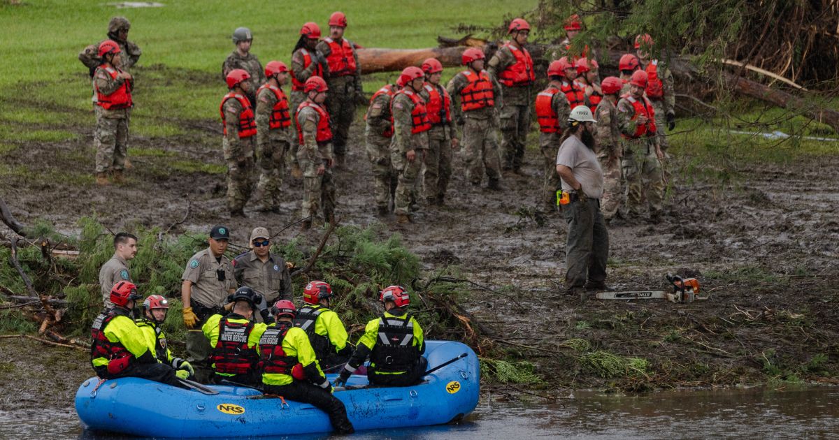 Search and recovery workers dig through debris looking for any survivors or remains of people swept up in the flash flooding at Camp Mystic on July 6, 2025, in Hunt, Texas.